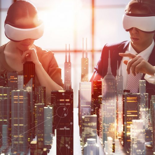 two business persons are developing a project using virtual reality goggles. the concept of technologies of the future